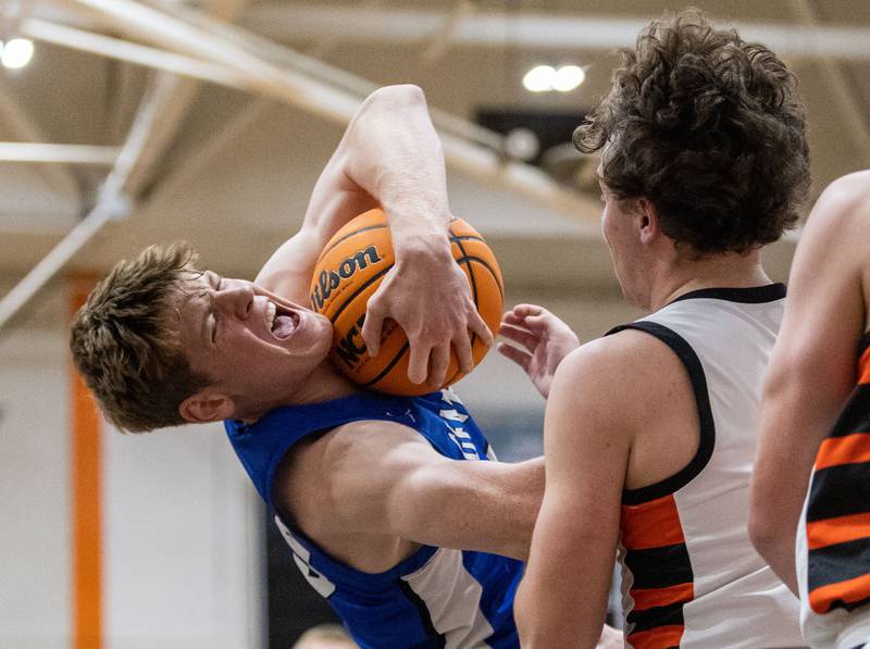 Geneva’s Hudson Kirby wrestles for the ball during a game against Wheaton Warrenville South at Wheaton Warrenville South High School on Tuesday, Dec. 3, 2024.