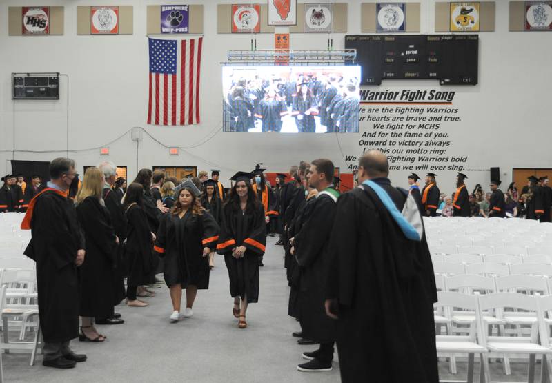 Graduates march into the gym Saturday, May 21, 2022, during the McHenry High School’s 102nd Commencement Ceremony. The ceremony was moved inside and split into two ceremonies because of the rainy weather.