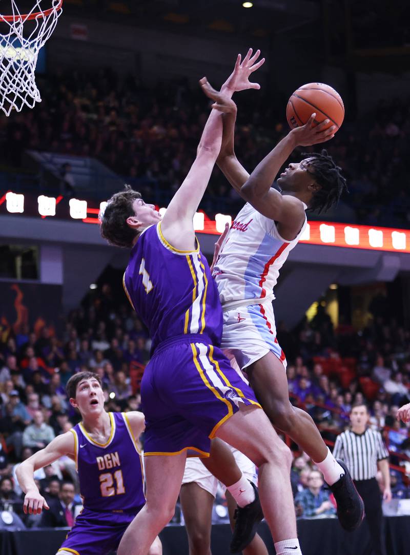 Kenwood Academy's Jaden Smith goes up against Downers Grove North's Jake Reimer during the boys 4A super-sectional game between Kenwood Academy and Downers Grove North high school in Chicago on Monday, March 6, 2023.