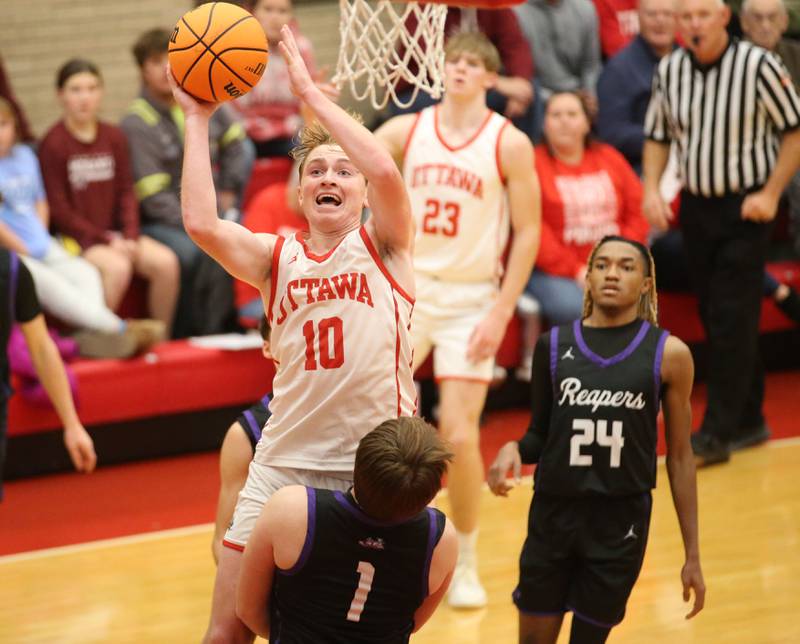 Ottawa's Evan Snook eyes the hoop as Plano's Kaiden Schimandel defends during the Dean Riley Shootin' The Rock Thanksgiving Tournament on Tuesday, Nov. 26, 2024 in Kingman Gym at Ottawa High School.