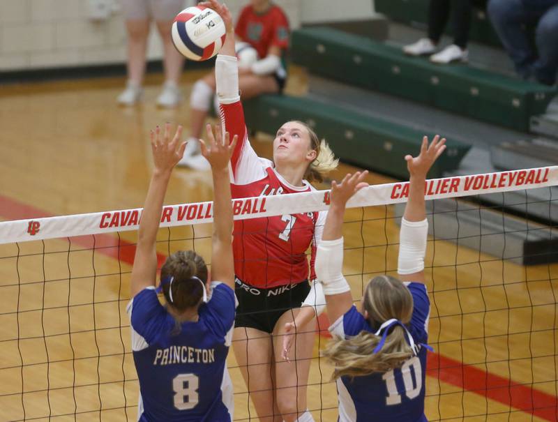 L-P's Aubrey Duttlinger spikes the ball past Princeton's Keighley Davis and teammate Makayla Hecht on Tuesday, Aug. 26, 2025 in AJ Sellett Gymnasium at L-P High School.