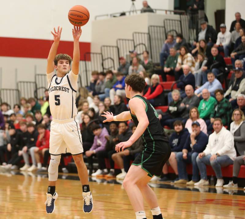 Fieldcrest's Connor Reichman shoots a three-point basket over Rock Falls's Ryken Howard during the 49th annual Colmone Classic on Saturday, Dec. 9, 2023 at Hall High School.