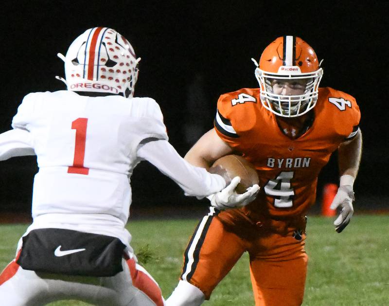 Byron's Dawson Criddle (4) looks to evade Oregon's Benny Olalde (1) on Friday, Oct. 31, 2025 in the first round of the 3A state playoffs held at the Everett Stine Stadium in Byron.