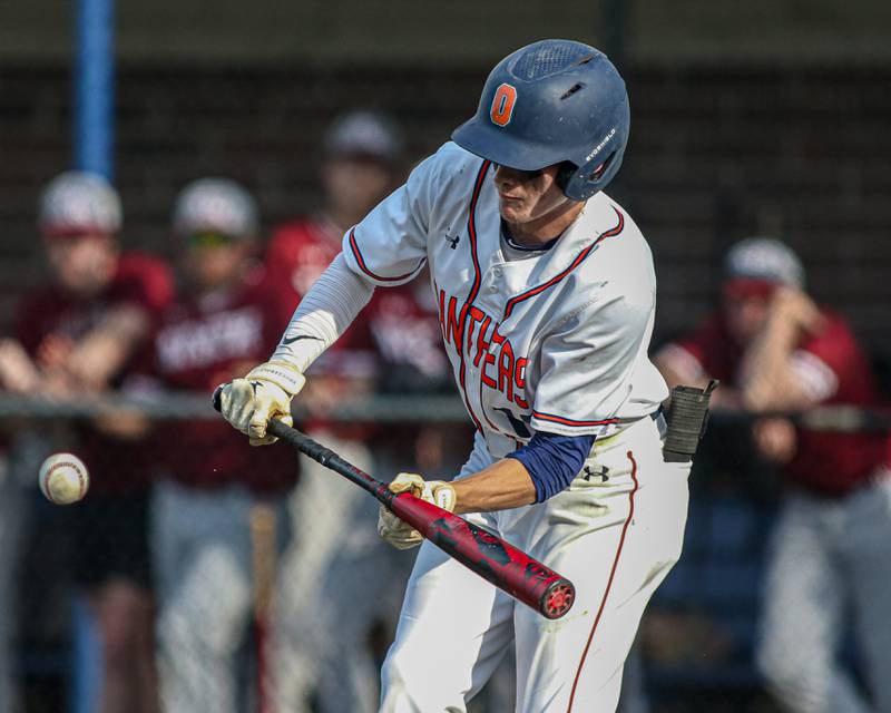 Oswego's Luke Voelker (19) bunts for a hit during Class 4A Romeoville Sectional semifinal game between Plainfield North at Oswego.  June 1, 2023.