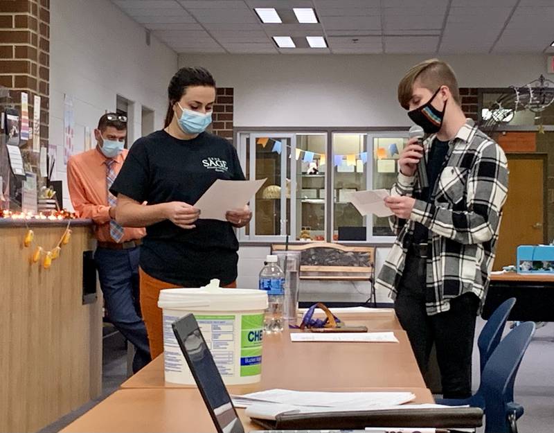 Sexuality and Gender Equity (SAGE) Club Faculty Advisor Carly George, left, and Student Leader Cloe Mishler, right, address the Genoa-Kingston Board of Education during a meeting held Tuesday, Nov. 16, 2021, in the Genoa-Kingston High School Media Center.