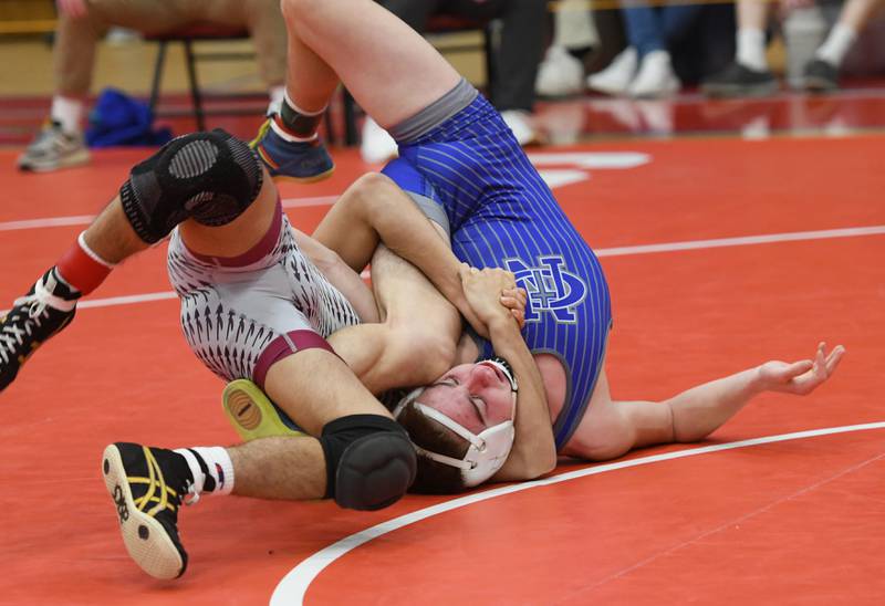 Newman's Brady Grennan twists to try and break a hold by Dakota's TJ Silva during their 126-pound match at the 1A Oregon Wrestling Sectional on Friday night.
