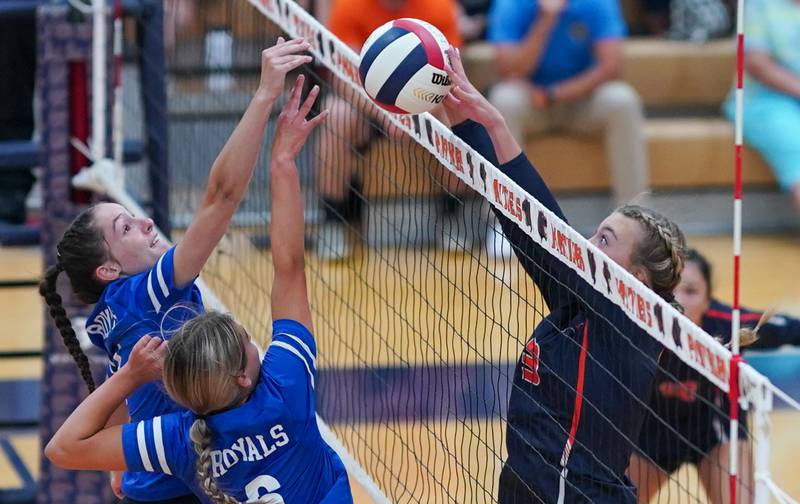 Oswego’s Riley Borrowman (right) defends the net against Rosary’s Reese Gilla (4) and Lily Caruso (6) during a volleyball match at Oswego High School on Tuesday, Aug 29, 2023.