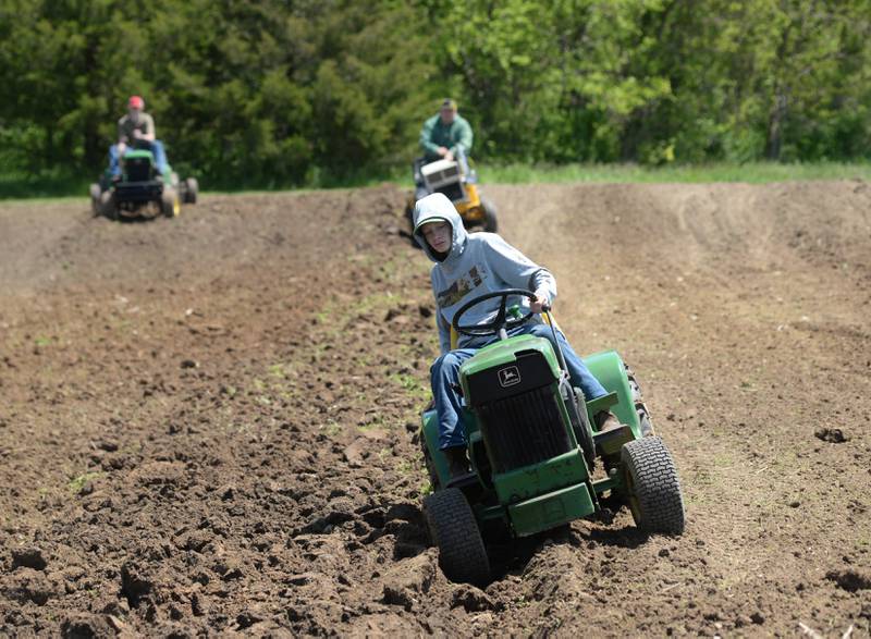 Garrett Edwards, 14, of Elkhorn, Wisconsin, plows with his John Deere 112 at the 14th AJ's Garden Tractor Jamboree on Saturday, May 20.