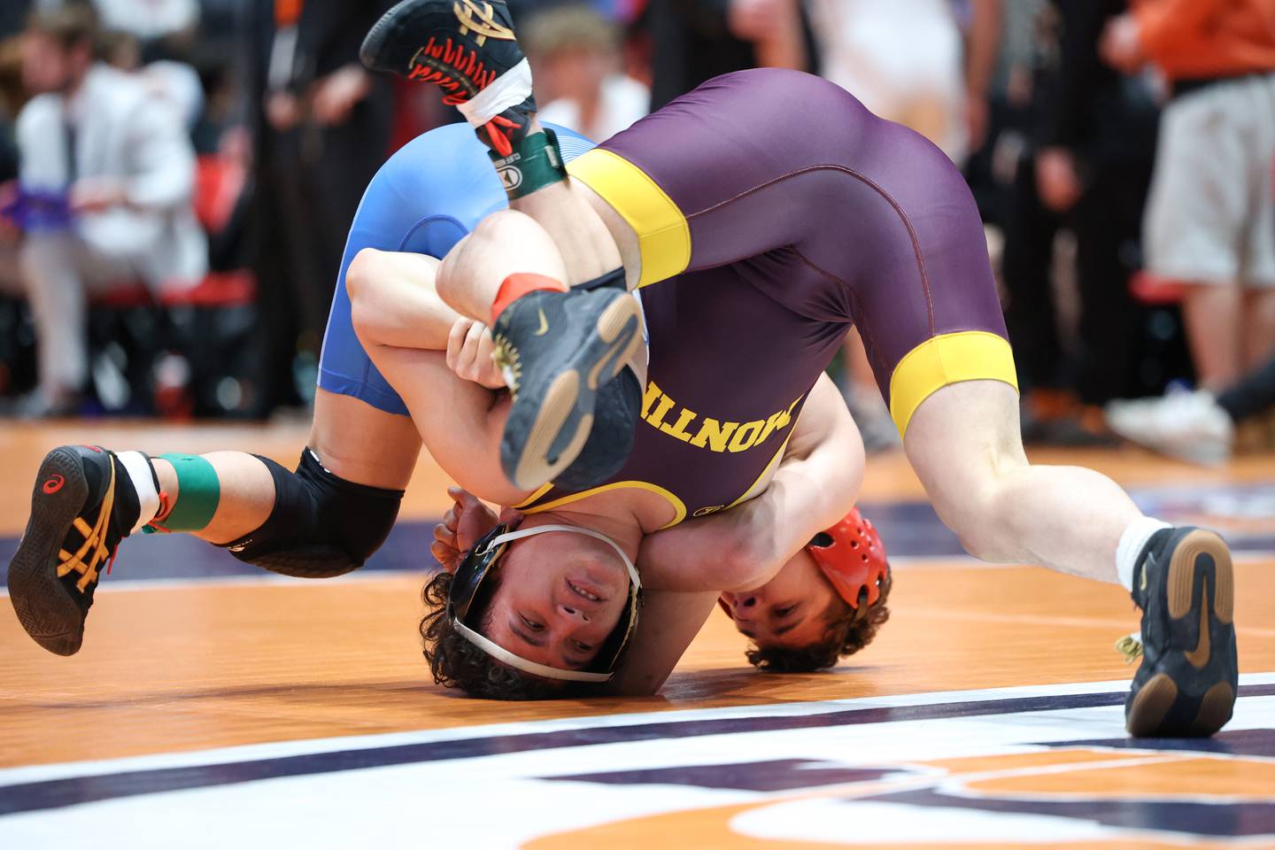Montini's Isaac Mayora, near, is flipped by Marmion Academy's Logan Conover in the 144-pound match during Marmion Academy's victory over Montini in the IHSA Class 3A Dual Team State championship on Saturday, Feb. 28, 2026.