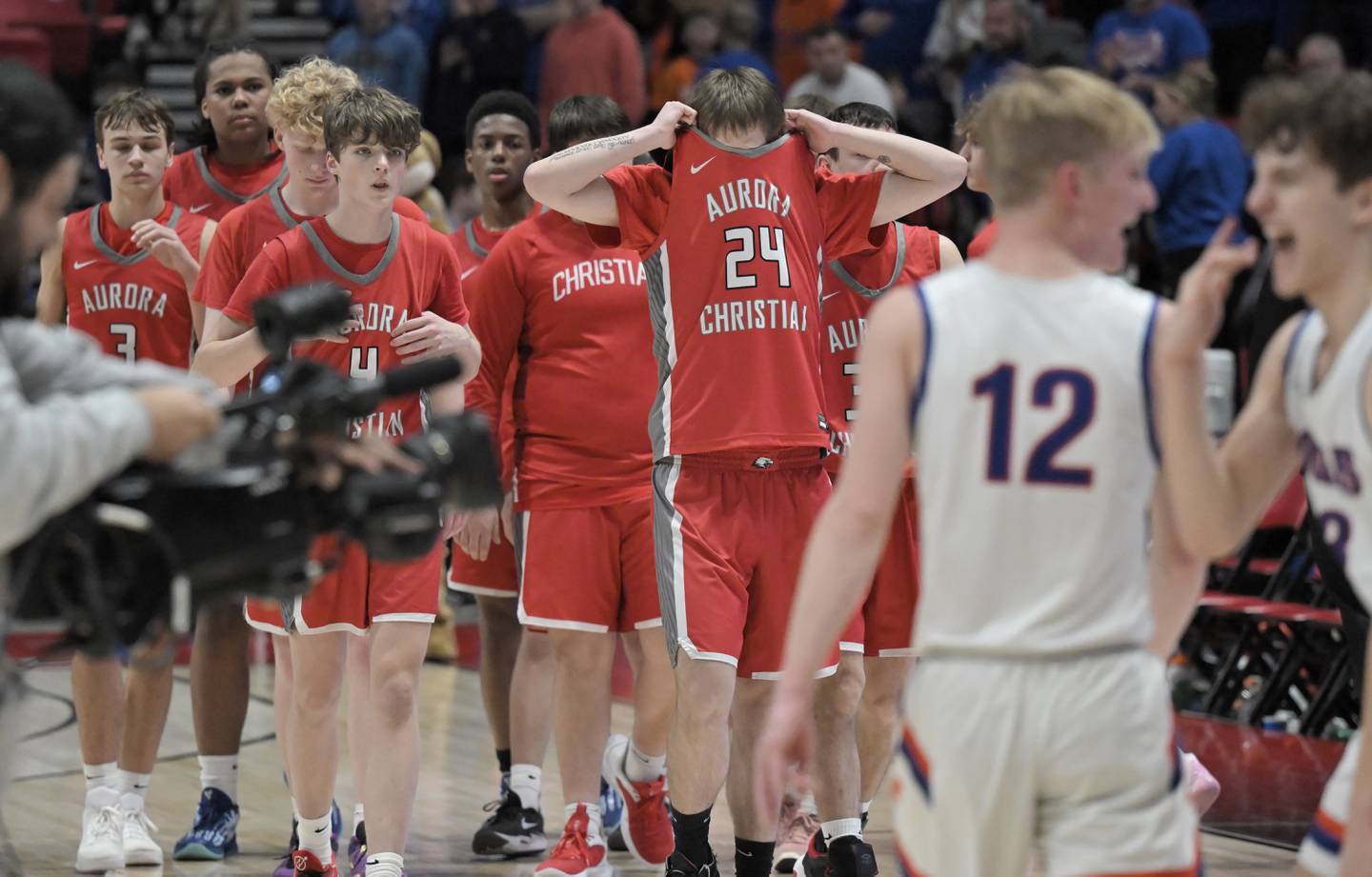 Aurora Christian’s Landon Schuster (24) and teammates come off the floor as Eastland begins to celebrate their win in a IHSA Class 1A boys basketball supersectional at Northern Illinois University in DeKalb on Monday, Mar. 10, 2025.