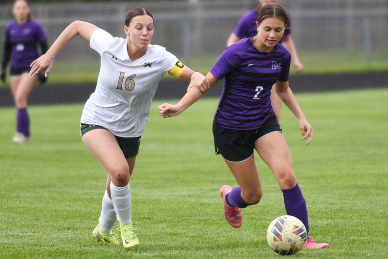 Bishop McNamara's Ava Brockell, left, chases down Manteno's Peyton Boros during a game at Manteno Wednesday, April 29, 2026.