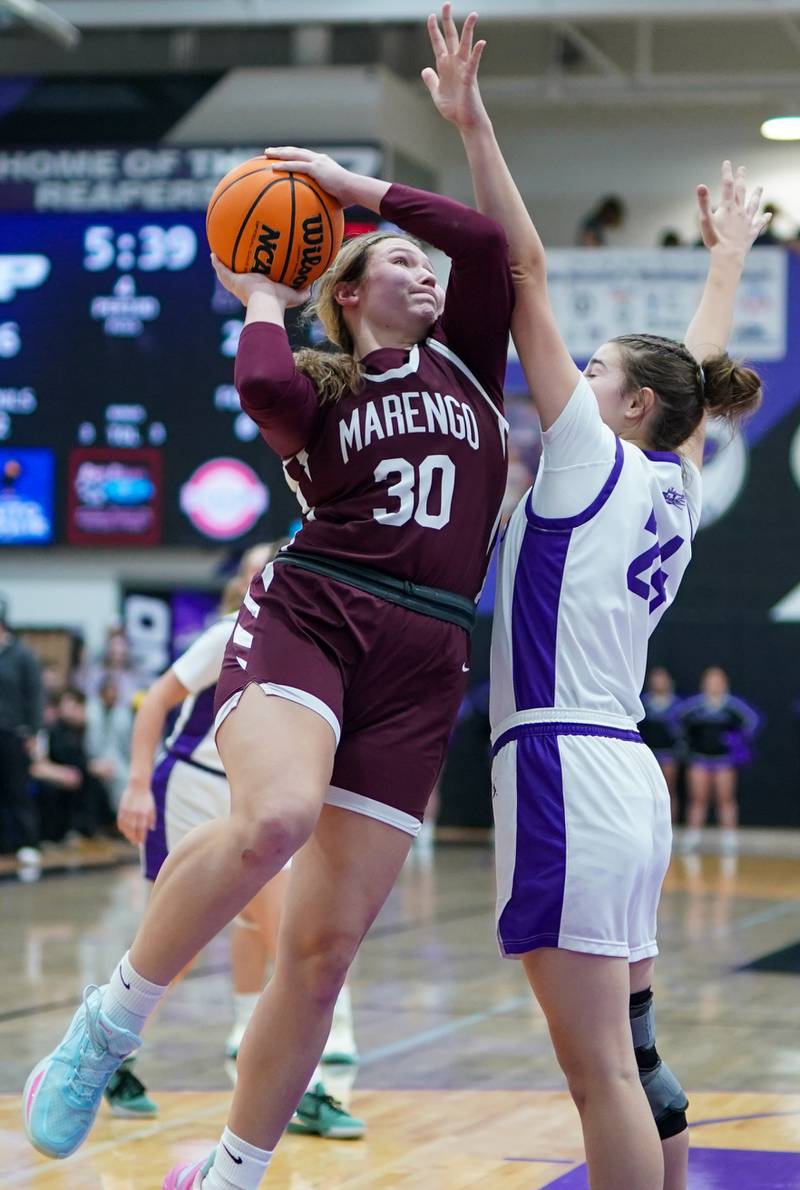 Marengo’s Macy Noe (30) shoots the ball in the post against Plano's Chloe Rowe (24) during a basketball game at Plano High School on Wednesday, January 29, 2025.