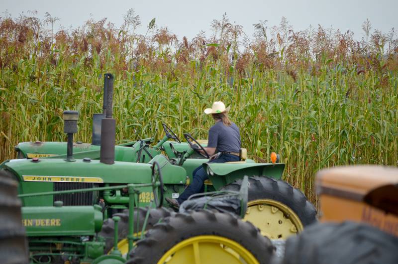 An AETA member is pictured on a John Deere tractor and ready to harvest the corn on Saturday, Sept. 17. John Deere tractors and implements were featured at this year’s Working Farm Show on IL Hwy. 92 in rural Geneseo. Thousands attended the annual weekend event for demonstrations, food and craft vendors, and good old-fashioned family fun.