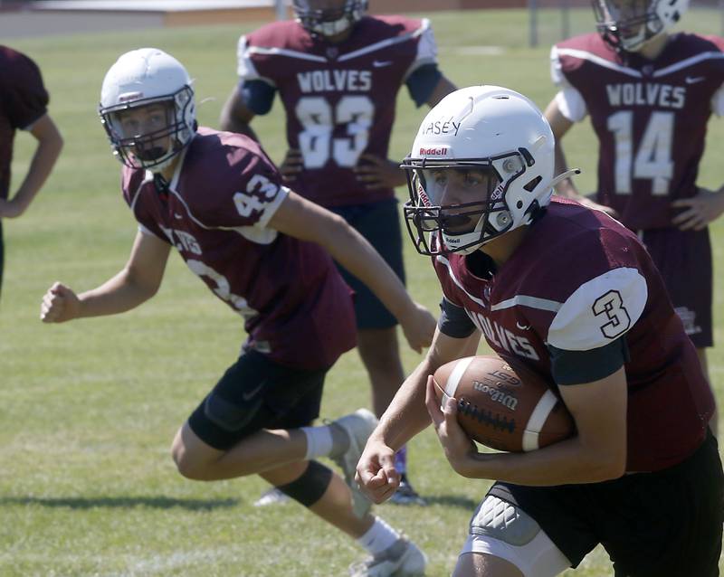 Prairie Ridge’s Tyler Vasey runs with the ball during summer football practice Tuesday, July 12 2022, at Prairie Ridge High School in Crystal Lake.
