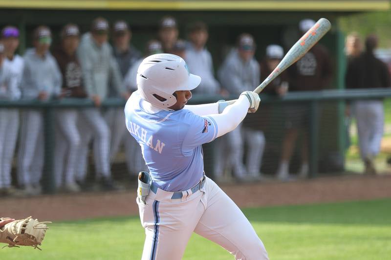 Nazareth’s Kim Alikhan drives in a run against Joliet Catholic on Wednesday, April 29, 2026 in Joliet.