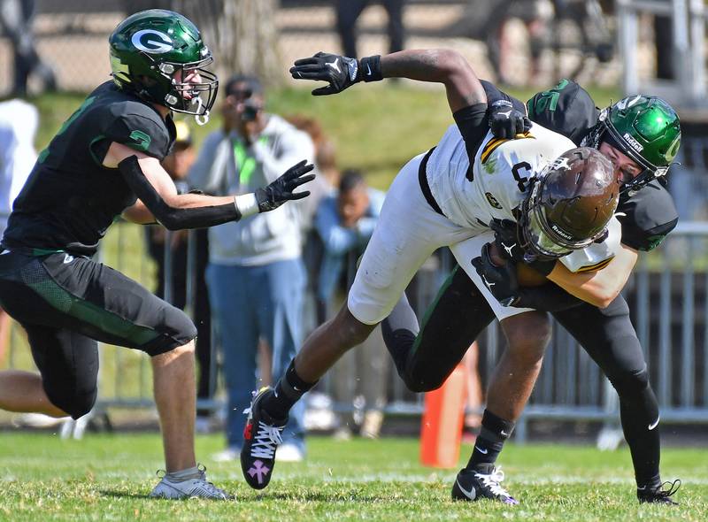 Glenbard West’s Finn Sheeley (right) tackles Joliet Catholic’s Jayden Armstrong (3) after a catch during a game on September 6, 2025 at Glenbard West High School in Glen Ellyn.