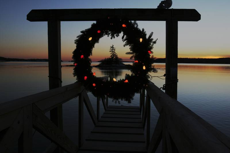 FILE - This Tuesday, Dec. 18, 2007 file photo shows a Christmas wreath decorated with lights at the end of a dock at sunset on Linekin Bay in East Boothbay, Maine. Wintertime can trigger true but transient depression in some people, a condition sometimes called Seasonal Affective Disorder. It's linked with lack of sunlight in winter and some scientists think affected people overproduce the sleep-regulating hormone melatonin. Research suggests it affects about 6 percent of the U.S. population and rates are higher in Scandinavia. But contrary to popular belief, suicides peak in springtime, not winter. No one has figured out why. (AP Photo/Pat Wellenbach)
