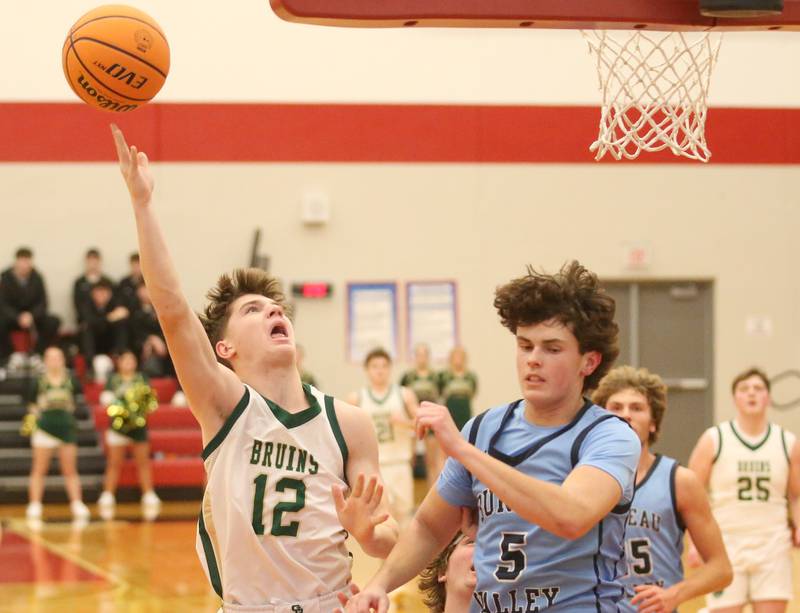 St. Bede's Carson Riva lets go of a shot over Bureau Valley's Logan Philhower during the 50th annual Colmone Classic on Thursday, Dec. 12, 2024 at Hall High School.