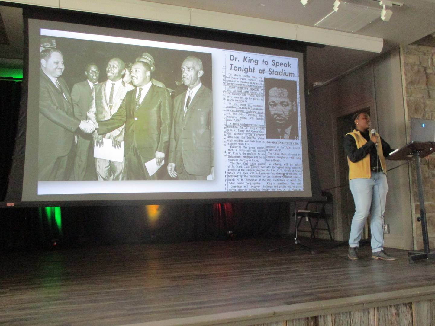 H'Aeneise Coopwood, membership coordinator at the Joliet Area Historical Museum in Joliet, gives a presentation on local Black history in Joliet in front of a blown-up image of an article from The Herald-News about a 1965 visit to Joliet by Martin Luther King Jr. Feb. 22, 2025