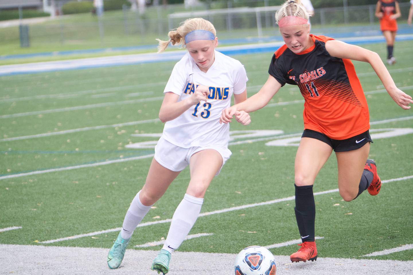 Wheaton North's Piper Harborth battles for the ball with St. Charles East's Ella Stehman at the Class 3A Regional Final in Wheaton on May 20,2022.