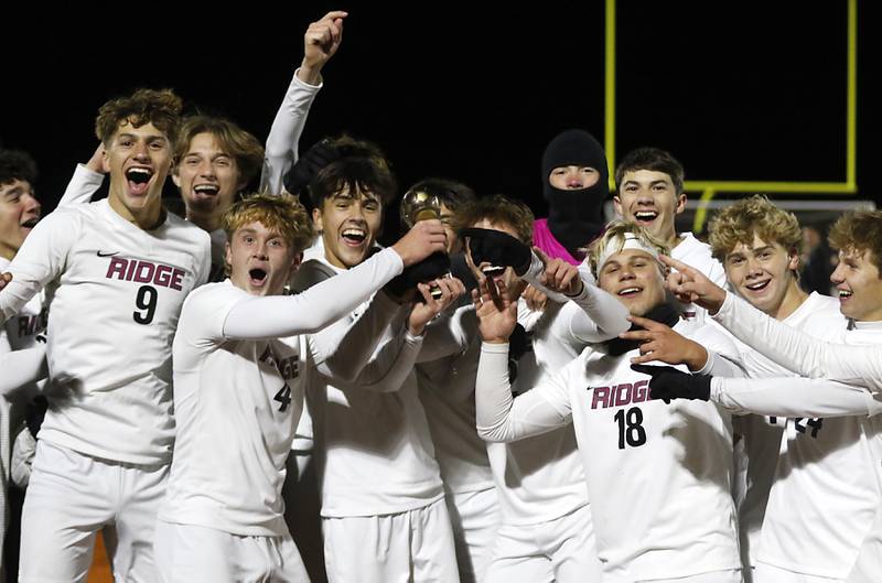 Prairie Ridge players celebrate their 2-1 win over McHenry to win the Fox Valley Conference championship after their soccer match  on Tuesday, Oct. 15, 2024, at McCraken Field in McHenry.