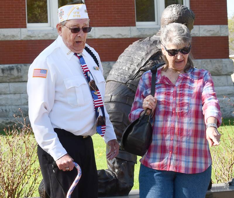 Oregon veteran Lee Ossmann and his wife, Sue, look at some of the memorial pavers around the veteran's memorial on the north side of the Ogle County Courthouse Square on Thursday, April 23, 2026. Ossmann's Hometown Hero banner was the first installed on a city street pole in downtown Oregon.