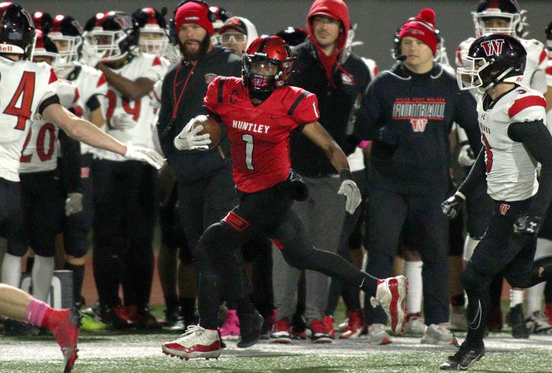 Huntley’s Bryce Walker runs the ball against Niles West in first-round Class 8A playoff football action at Huntley Friday.