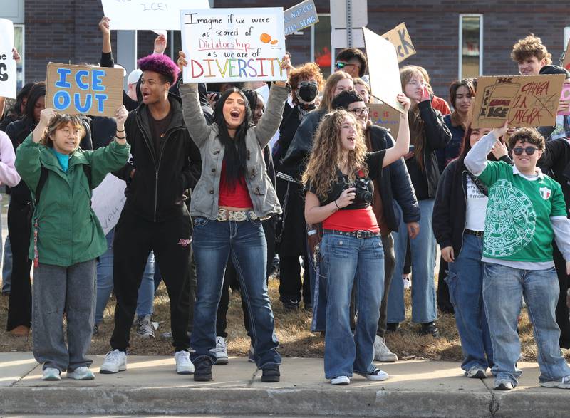 Northern Illinois University students hold signs and chant Friday, Feb 13, 2026, in front of the DeKalb Police Department, during a protest against recent nationwide U.S. Immigration and Customs Enforcement activity.