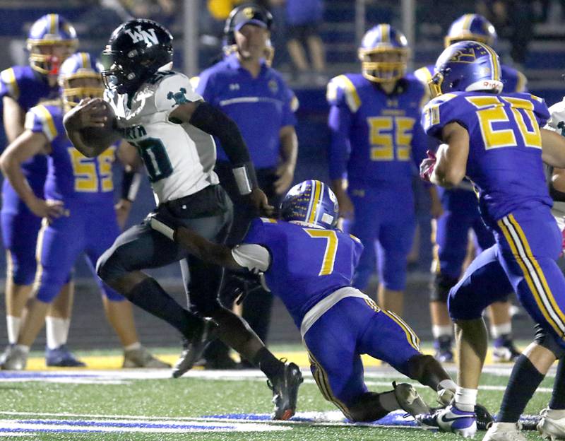 Woodstock North's David Randecker runs with the ball as Johnsburg's Jarrel Albea tries to tackle him during a Kishwaukee River Conference football game on Friday, Sept. 26, 2025, at Johnsburg High School.
