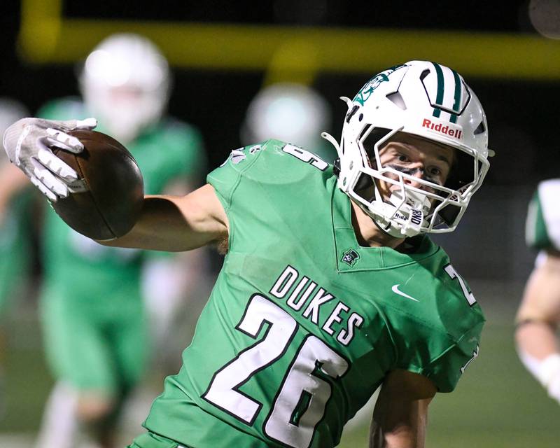 York's Henry Duda (26) breaks a tackle and runs in for a 56-yard touchdown on Friday Oct. 17, 2025, while taking on Glenbard West held at York High School.