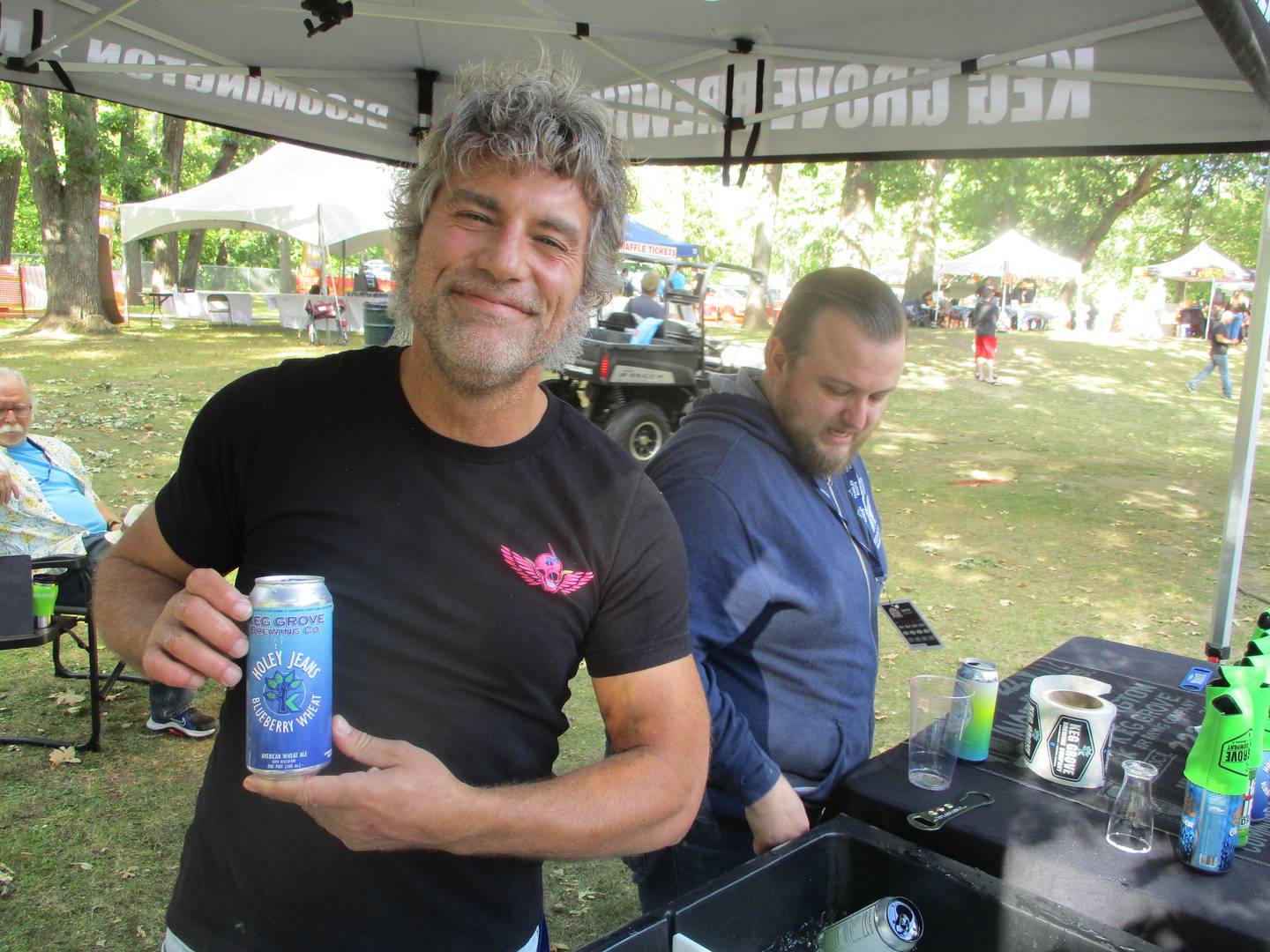 Brian Scott holds up a can of Keg Grove Brewing Company's "Holey Jeans" beer, which was an award winner at the Illinois State Fair this year, at the Morris Beer Festival on Saturday. Sept. 6, 2025