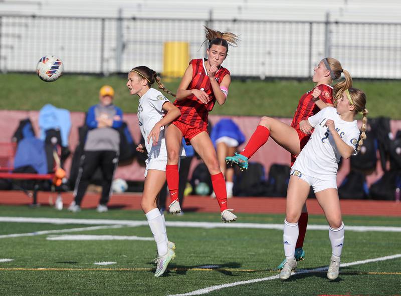 Hinsdale Central's Carter Knotts gets some air going for the ball during the girls varsity soccer match between Lyons Township and Hinsdale Central high schools in Hinsdale on Tuesday, April 18, 2023.