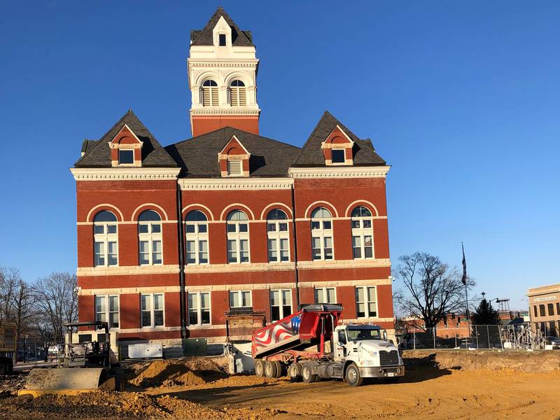 A Martin & Co. truck unloads gravel as workers fill in the basement of the old Ogle County Jail on Tuesday. Demolition of the 1969 jail started Dec. 5. See county board story on page 3 for more information.