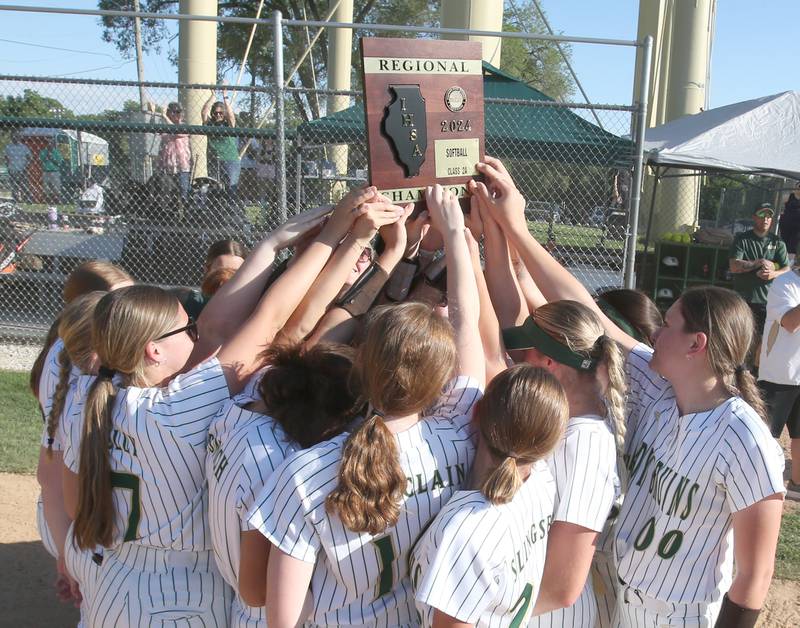 Members of the St. Bede girls softball team hoist the Class 2A Regional plaque after defeating Midwest Central on Friday, May 17, 2024 at at Abbot Phillip Davy Field.