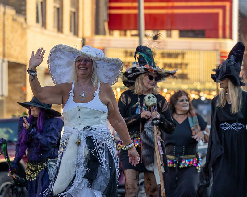 Parader dressed as apart of the 'Hocus Pocus Hags' waves to kids at the annual Princeton Halloween Parade on Saturday, Oct. 4, 2025 on Main Street in Princeton.