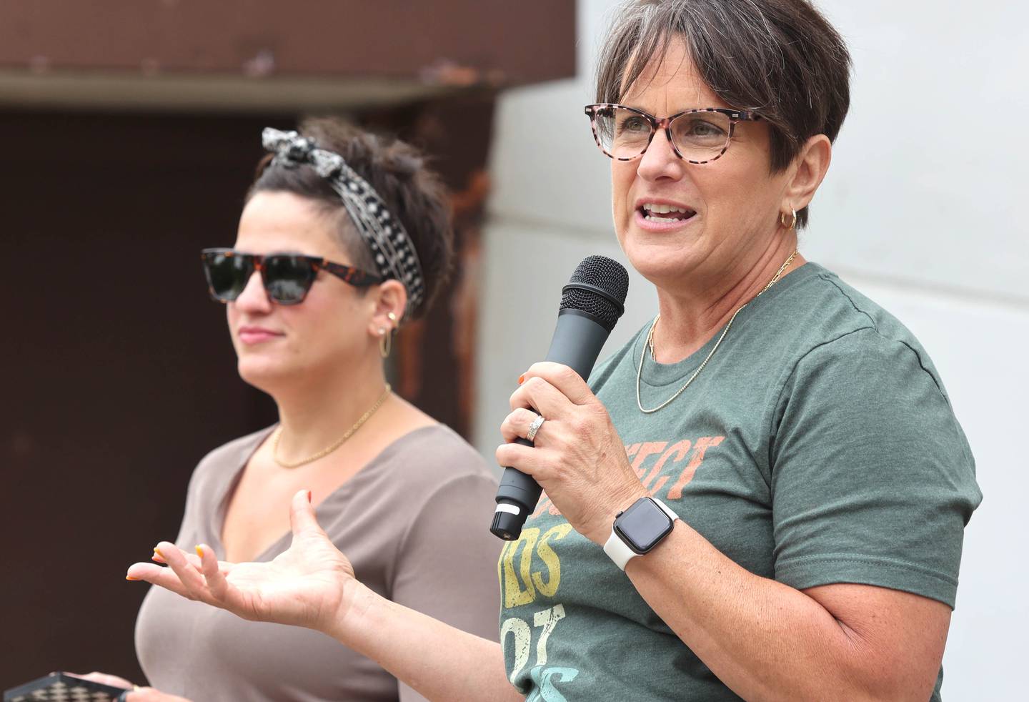 Event organizers Renae Lindenmayer (left) and Mary Lynn Buckner speak Saturday, June 11, 2022, during a March For Our Lives event at Hopkins Park in DeKalb. The March For Our Lives initiative advocates for, among other things, an end to gun violence, updated gun control legislation and policy targeting gun lobbyists.