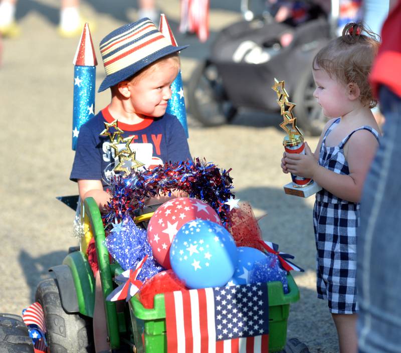 Ellis Fry, 2, of Mt. Morris (left) talks to Carly Robert, 1, of Polo, after the Let Freedom Ring Kiddie Parade on Monday. Sixty one kids took part in the event.