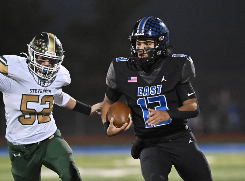 Lincoln-Way East's quarterback Jonas Williams (13) runs for a first down during the IHSA Class 8A Quarterfinals game against Stevenson on Friday, Nov. 15, 2024, at Frankfort. (Dean Reid for Shaw Local News)