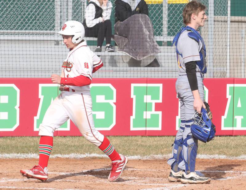 L-P's Adrian Arzola scores the teams first run as Mendota catcher Jack Gillespie watches the play on Thursday, April 3, 2025 at Huby Sarver Field inside the L-P Athletic Complex in La Salle.