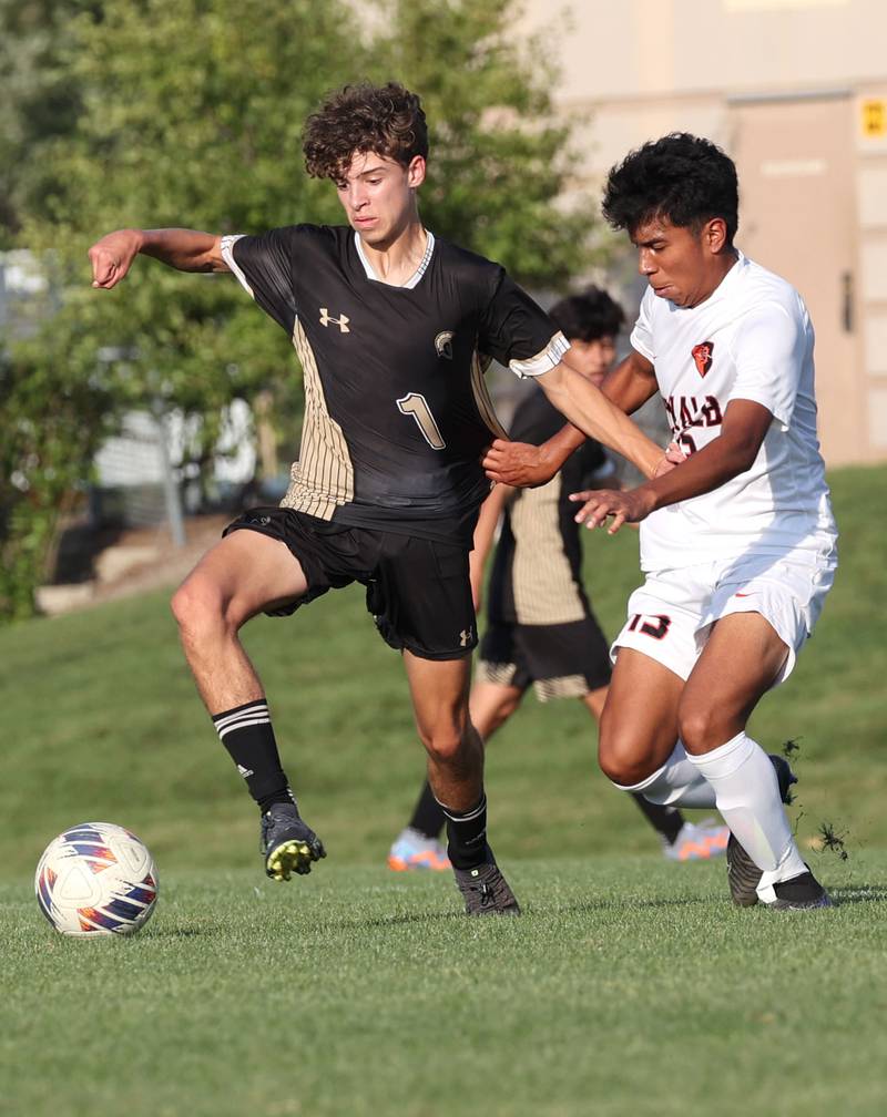 Sycamore's Noah Daykin tries to hold off DeKalb’s Henry Garcia Alvarez during their game Tuesday, Oct. 3, 2023, at Sycamore High School.