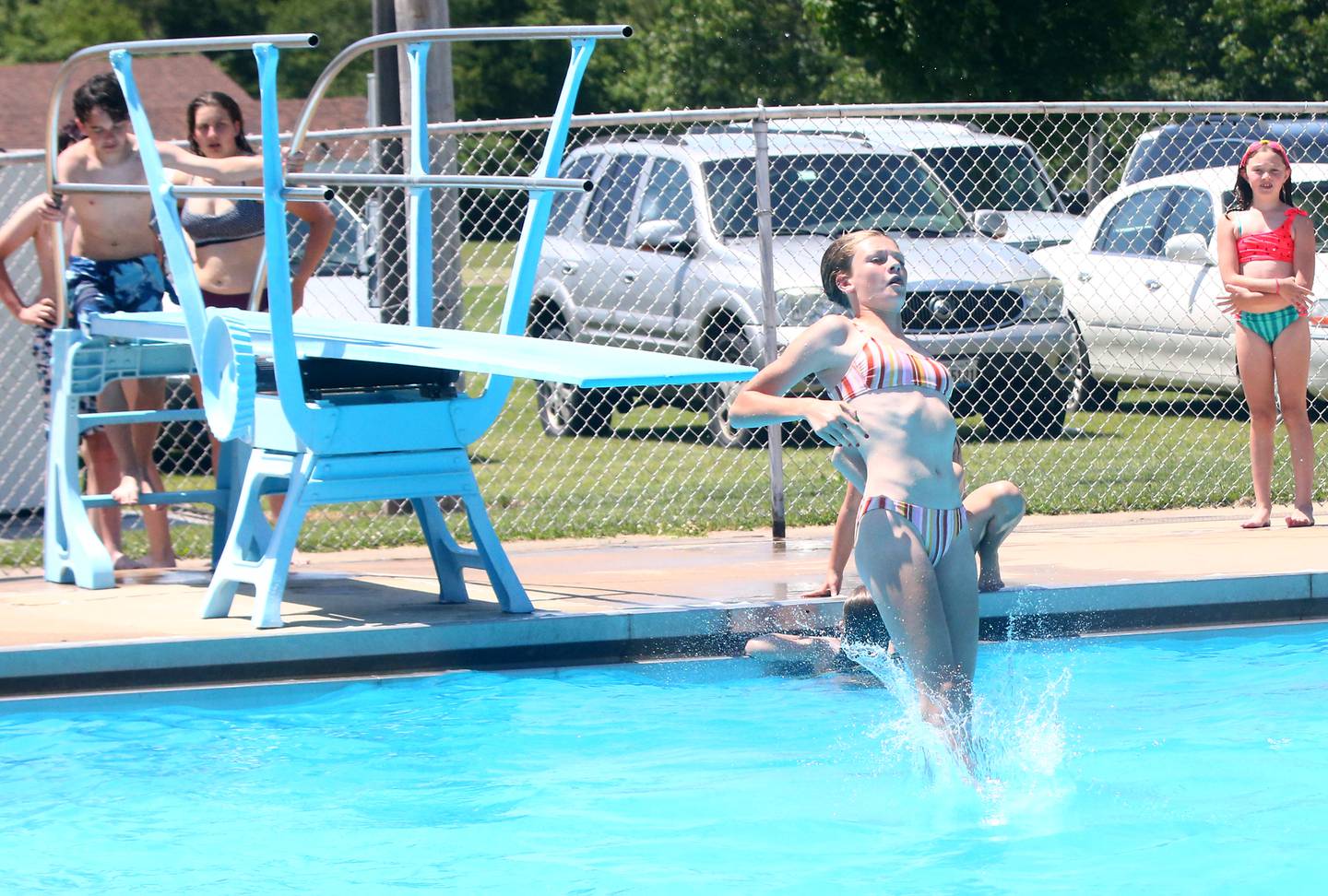 Aubrey Duttlinger 13, of Oglesby plunges into the water off the high diving board at the Oglesby Public Swimming Pool on Tuesday, June 14, 2022 in Oglesby.