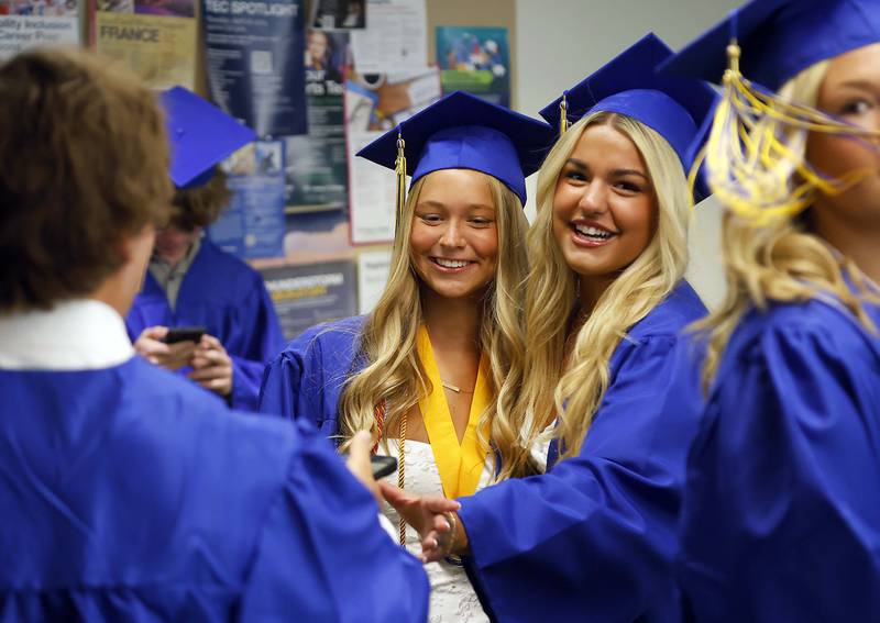 Wheaton North High School graduates take photos before their graduation ceremony Saturday, May 25, 2024 in the Physical Education Center of College of DuPage in Glen Ellyn.