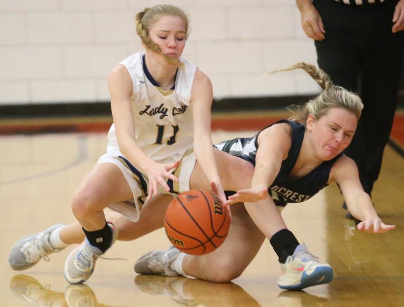 Marquette's Rylee Griffin and Fieldcrest's Vada Timmerman fall on a loose ball during the Integrated Seed Lady falcon Basketball Classic tournament on Monday, Nov. 13, 2023 at Flanagan High School.