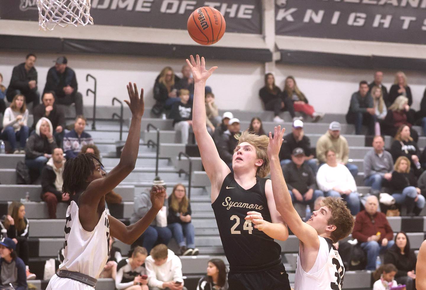 Sycamore's Lucas Winburn gets up a shot between Kaneland's Freddy Hassan and Parker Violett Friday, Jan. 6, 2023, during their game at Kaneland High School in Maple Park.