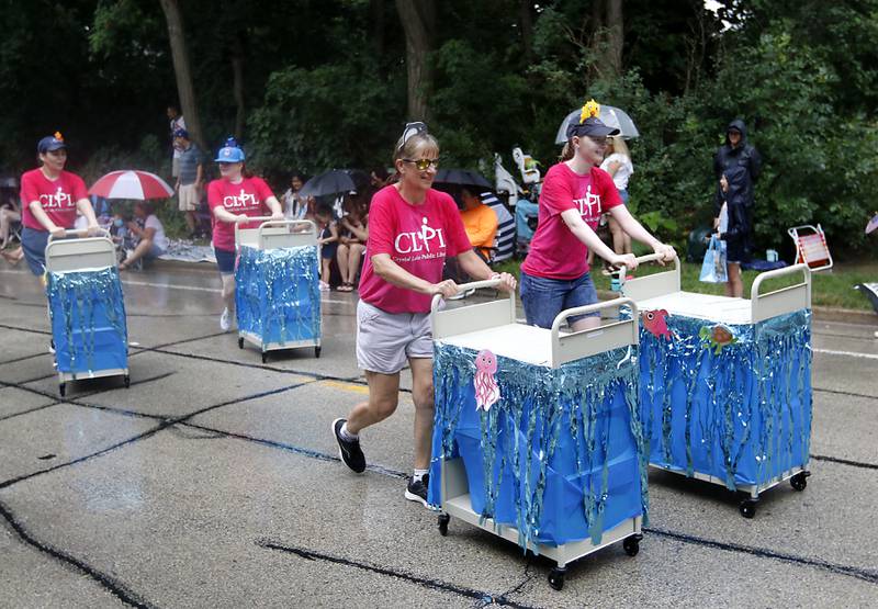 Members of the Crystal Lake Public Library push carts on Sunday, July 7, 2024, during Crystal Lake’s annual Independence Day Parade on Dole Avenue in Crystal Lake. This year’s parade feature close to 100 units.