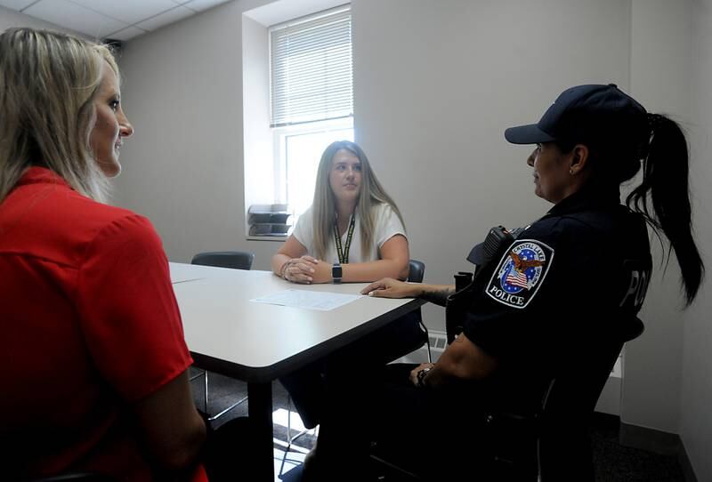 McHenry County Sheriff's Office social workers Amy Kristufek, left, and Taylor Keegan, center, talk with Crystal Lake police officer Ingrid Pinto about a mental health case she has on Thursday, June 16, 2022, in a conference room at the Crystal Lake Police Department. The social workers are part of the sheriff's office new social worker program. Social workers were hired to help police in situations involving mental health crisis. They go out on calls sometimes and follow up in the days, weeks and months that follow to help a person get to the resources they need.