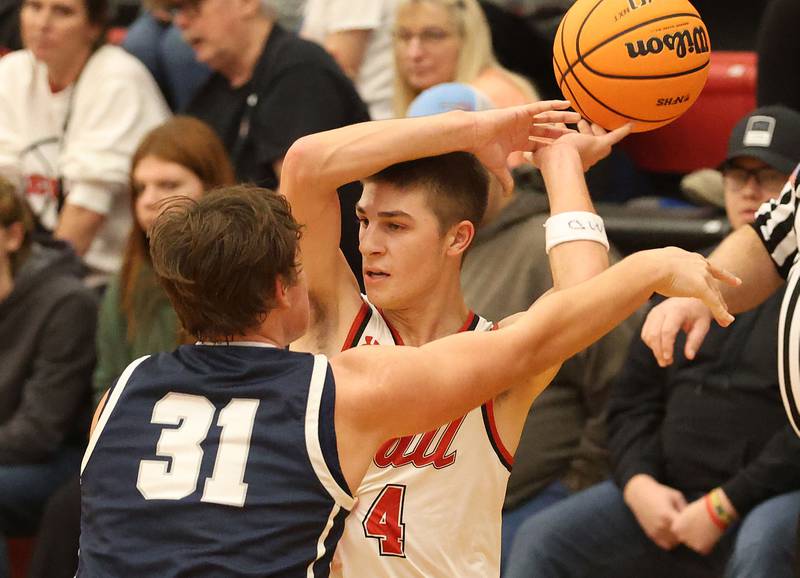 Hall's Luke Bryant looses control of the ball as he is guarded by Fieldcrest's Drew Overocker during the Colmone Classic on Friday, Dec. 12, 2025 at Hall High School.
