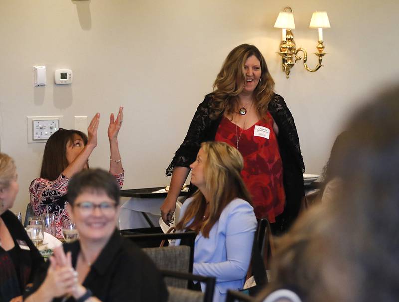 People clap for award recipient Cassandra Vohs-Demann as she is introduced during the Northwest Herald's Women of Distinction award luncheon Wednesday June 4, 2025, at Boulder Ridge Country Club, in Lake in the Hills. The luncheon recognized ten women in the community as Women of Distinction.