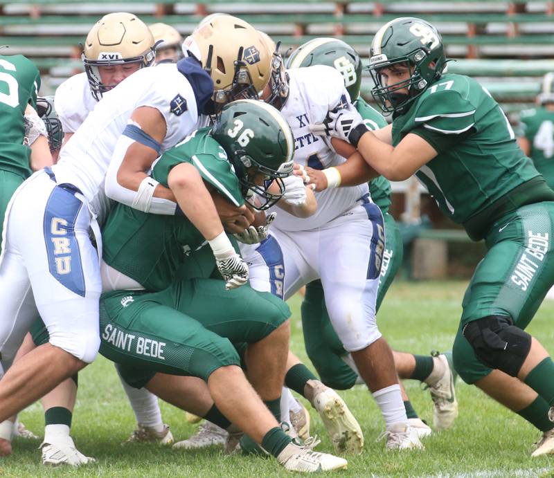 St. Bede's Landon Marquez gets pushed back by Marquette's Blayden Cassel during the Homecoming game on Saturday, Sept. 28, 2024 at St. Bede Academy.