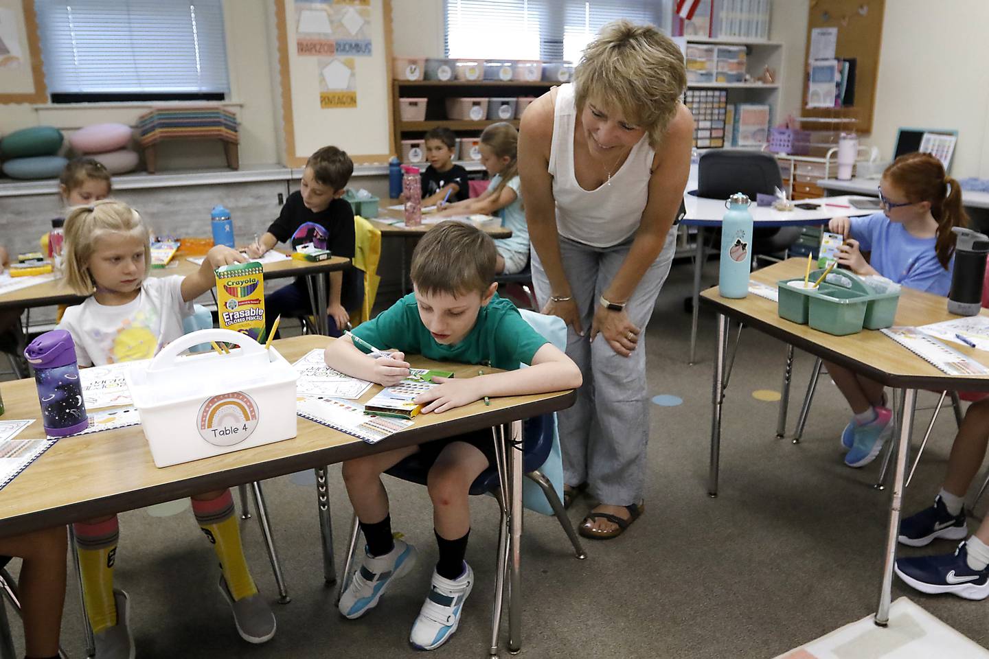 Landmark Principal Margaret Carey talks with second-grader Conner VanSiekle during the first day of school for McHenry's Landmark Elementary School on Wednesday, July 17, 2024.